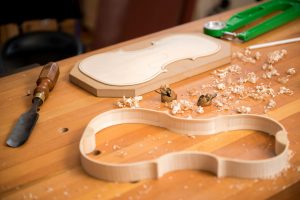 the luthiers workbench with finger planes and chisel